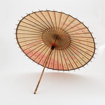 A set of six fans and two umbrellas and a wig/pony tail. Japan, early 20th Century.