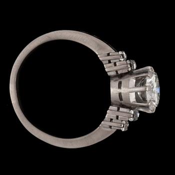 A ring with a brilliant-cut diamond flanked by baguette-cut diamonds. Total carat weights circa 1.80 cts.