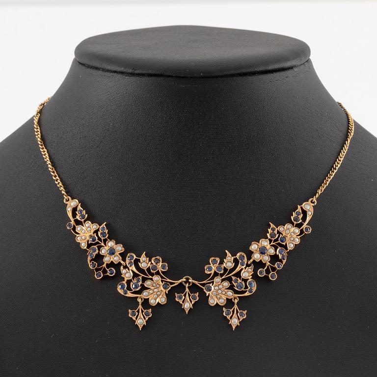 A 14K gold necklace with sapphires and pearls.