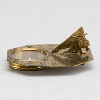 A brass travel sundial marked Le Maire et Fils Paris around 1700.