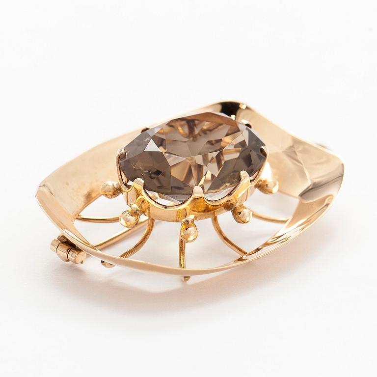 Helge Narsakka, riipus/rintaneula, 14K kultaa, savukvartsi, 1965.