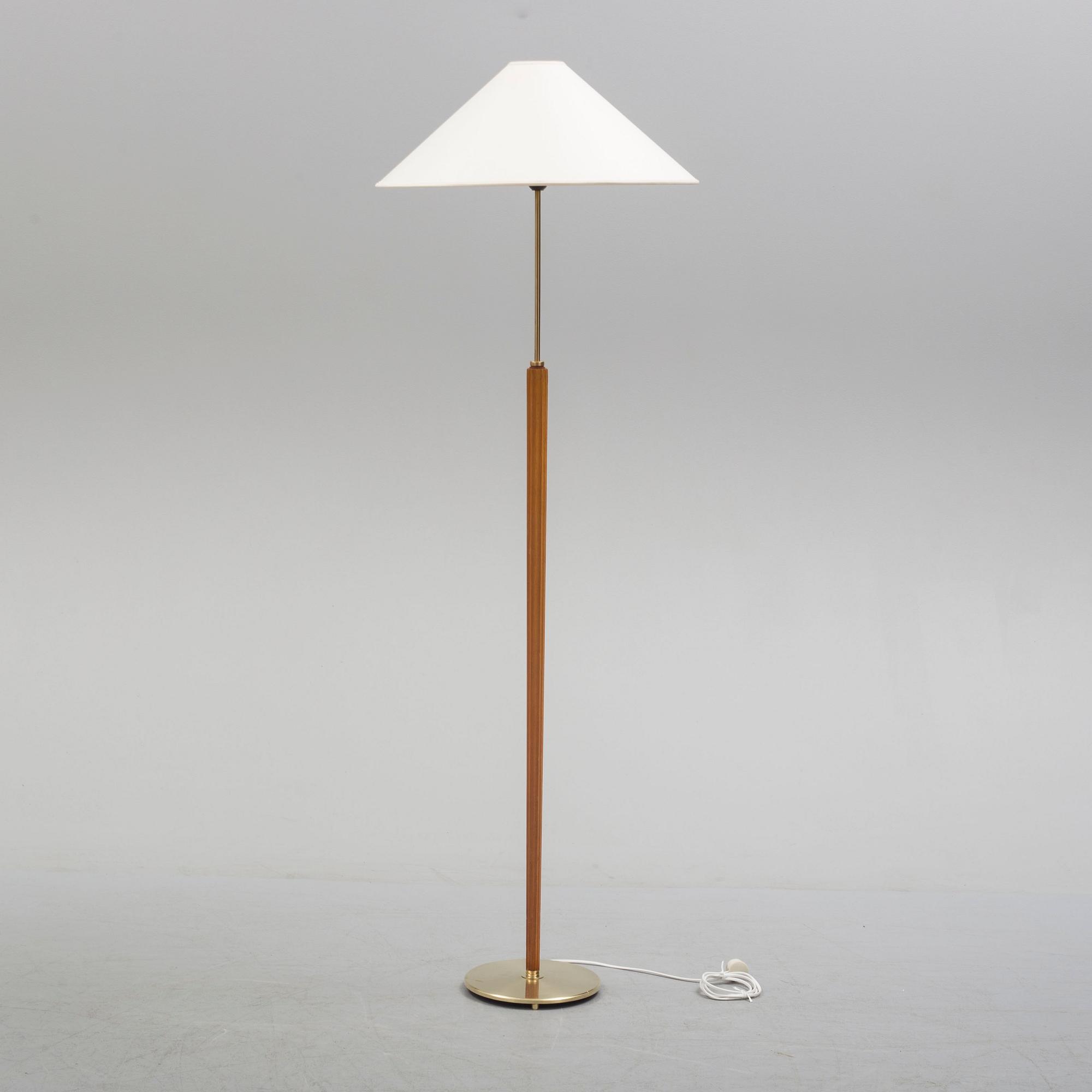 A Bergboms brass and beech standard light, 1940's.