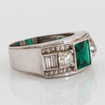 An 18K white gold WA Bolin ring set with a faceted emerald and old-, eight- and baguette-cut diamonds.