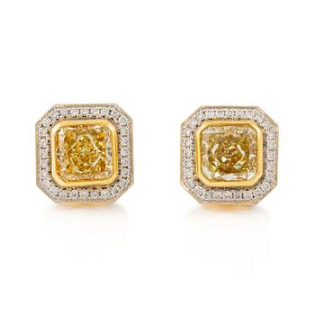 505A. A pair of platinum and gold earrings with two radiant-cut yellow diamonds.