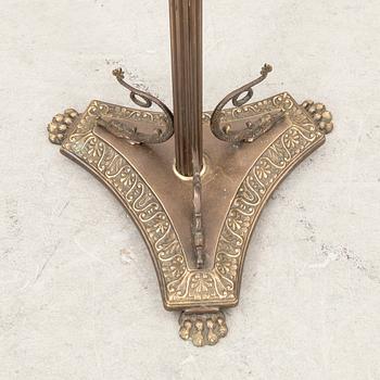 A brass coat hanger from the first half of the 20th century.