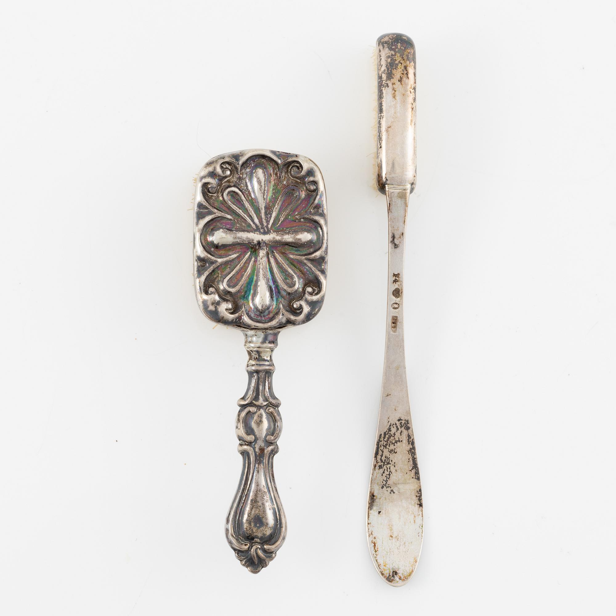 Two brushes, a hook, and a small mirror, silver and nickel silver.