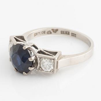 Ring, white gold, with dark sapphire and two brilliant-cut diamonds,