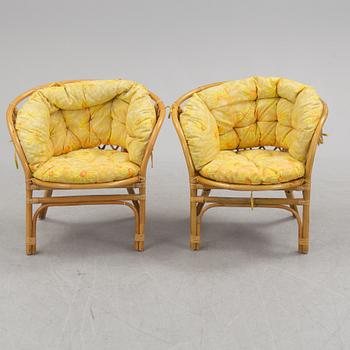 A 1970s four piece set of rattan garden furniture.