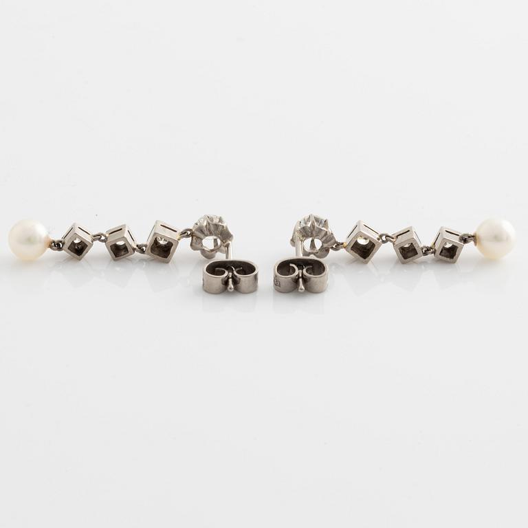A pair of 18K gold earrings with cultured pearls and round- and eight-cut diamonds.