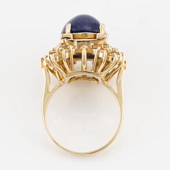 Ring in 14K gold with cabochon-cut sapphire and brilliant-cut diamonds.