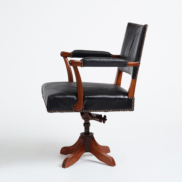 Josef Frank, a mahogany and black leather swivel chair, modified version of model 695, Svenskt Tenn, ca 1956-1957.