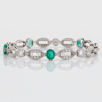 An 18K white gold bracelet set with faceted emeralds.