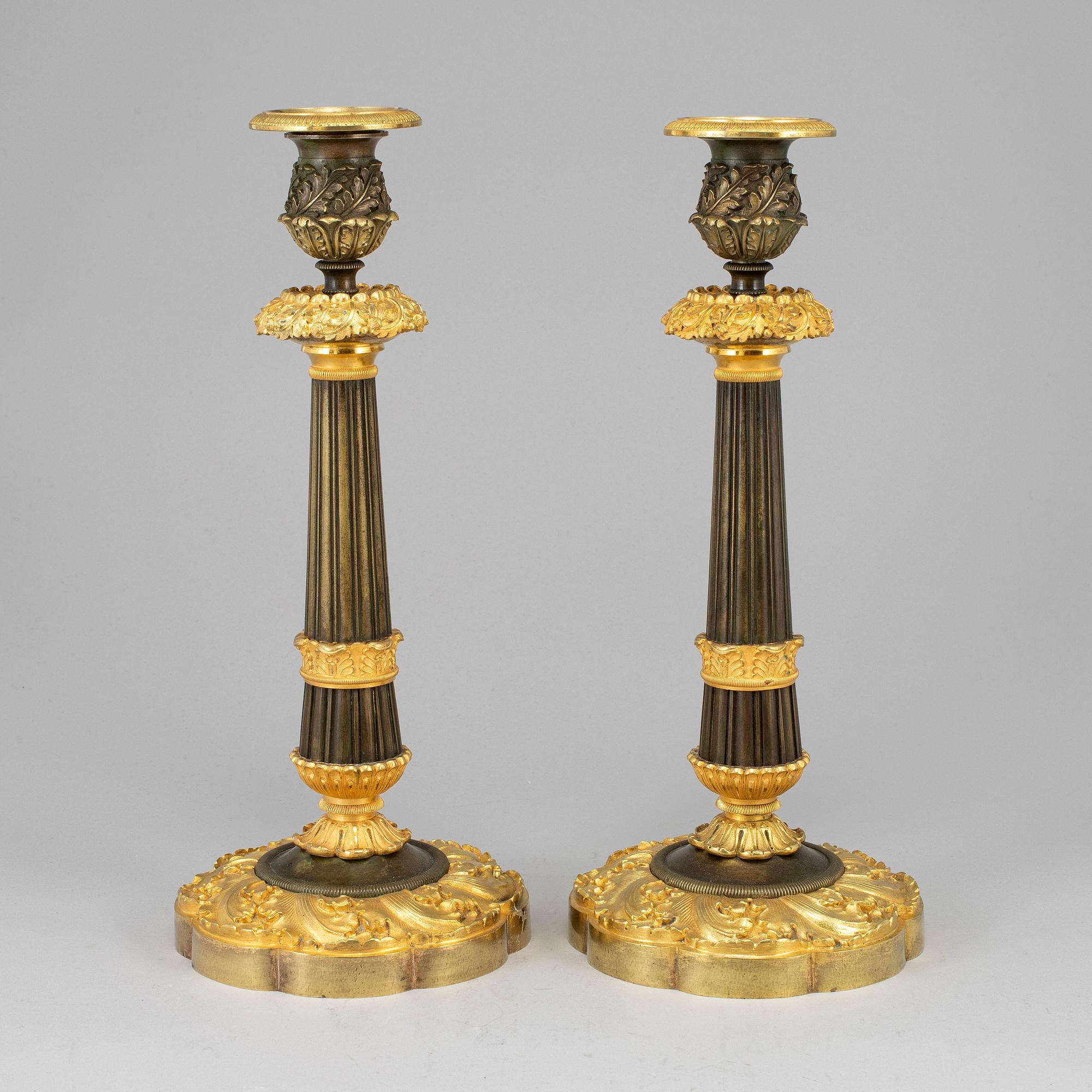A pair of ormolu late empire candlesticks, mid 19th century.