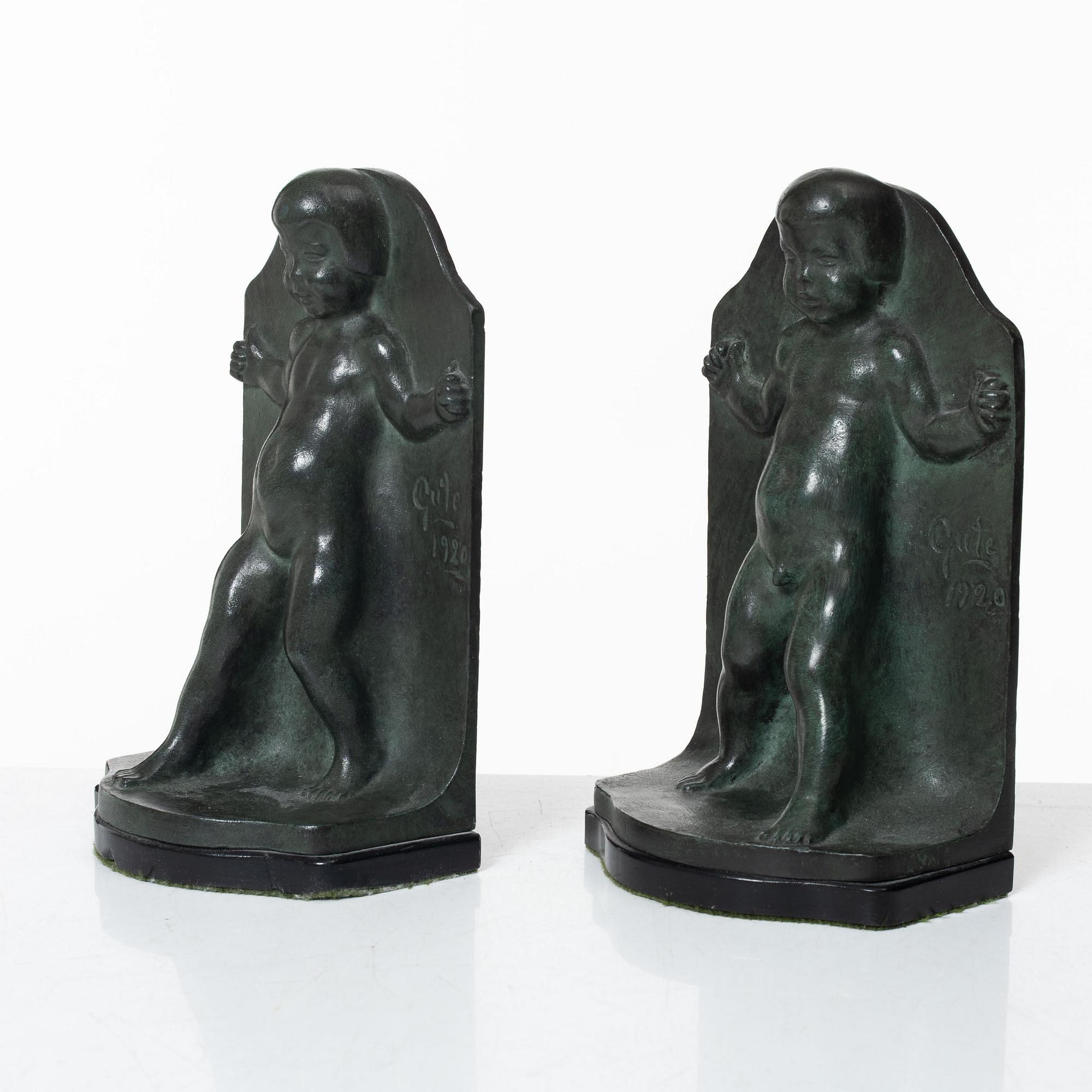 Axel Gute, a pair of patinated bronze bookends, dated 1920.