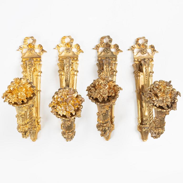 A set of four gilt bronze Louis XVI-style curtain holders, late 19th century.