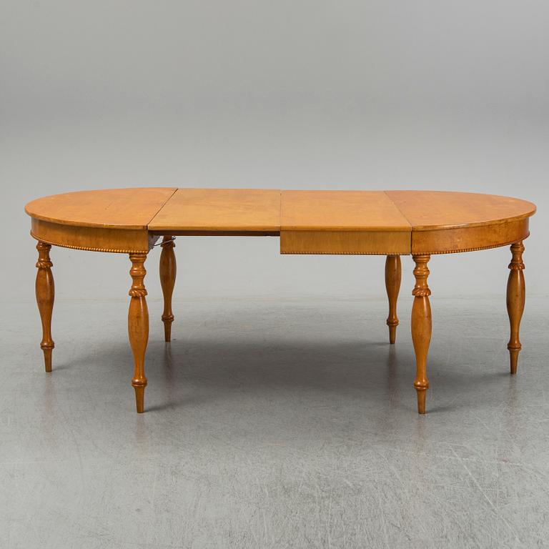 A mid 19th century birch dining table.