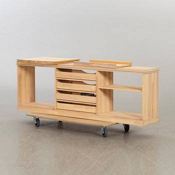 OLOF PIRA, A SIDEBOARD AND A BOOKCASE.