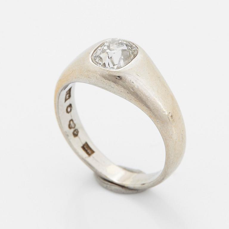 A platinum ring set with a cushion shaped old-cut diamond.