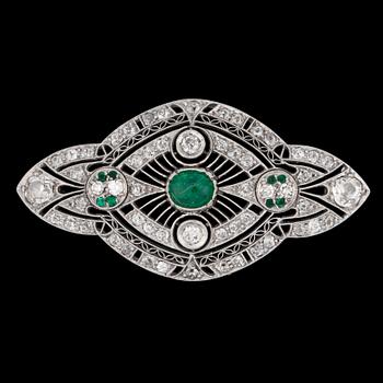 1150. A cabochon cut emerald and old cut diamond brooch, c. 1915.