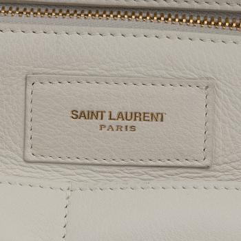 Yves Saint Laurent, a white leather handbag.