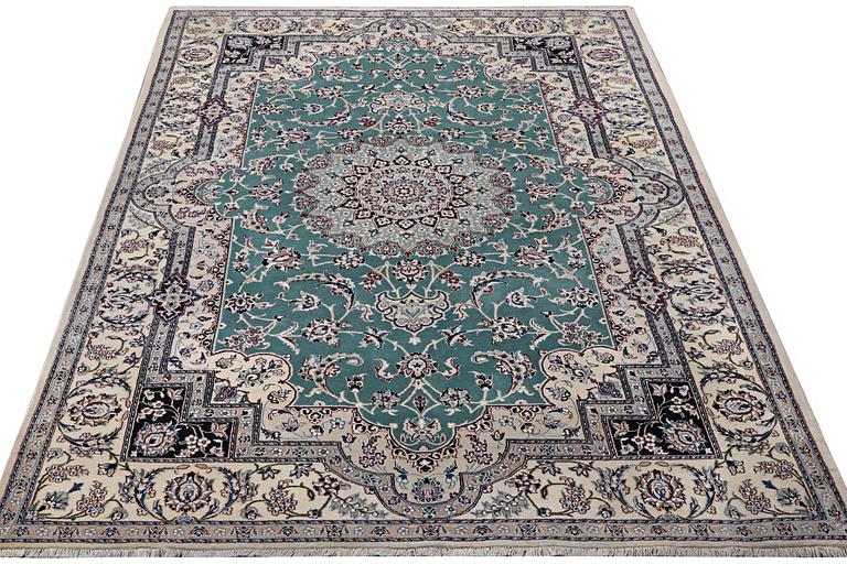 A Nain carpet, part silk, 9 laa, c. 300 x 201 cm.