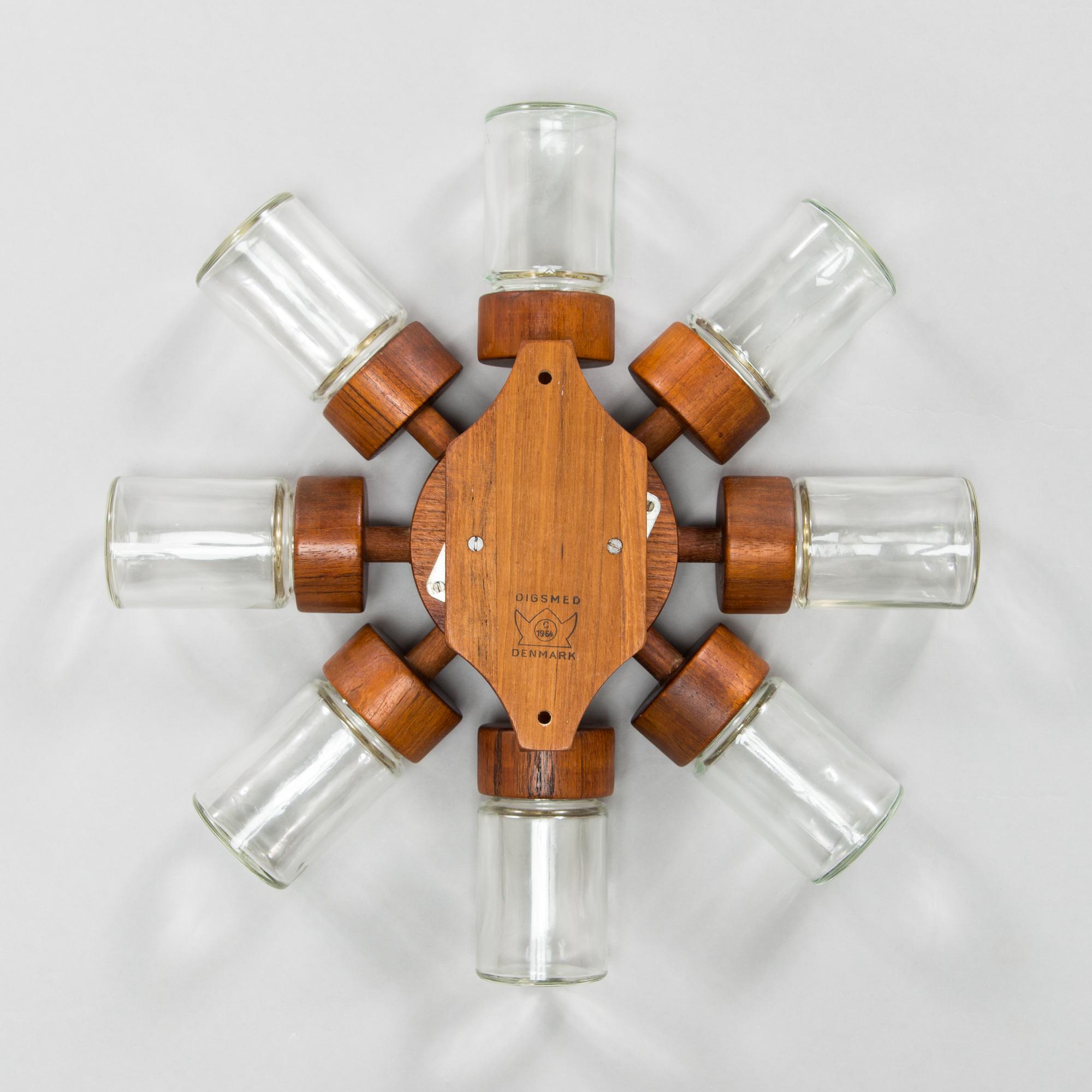 A Danish 1960s wall mounted spice rack in teak and glass from Digsmed.
