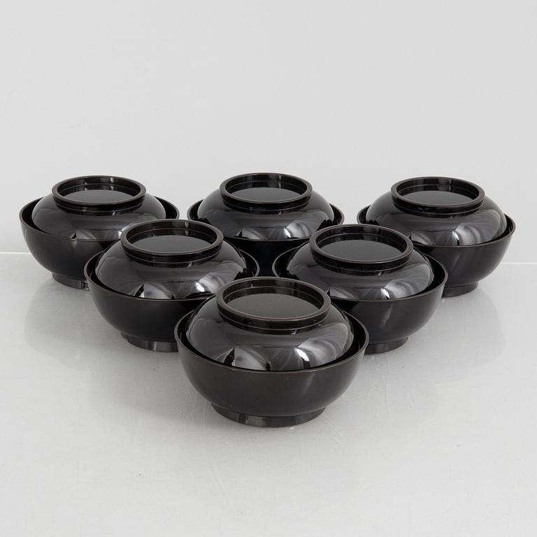 A set of six Japanese lacquer bowls with covers, 20th century.
