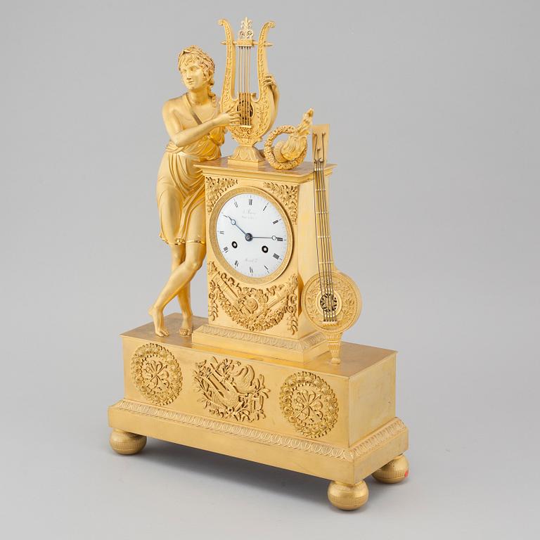 An Empire table clock, dial marked "L Ravrio Bronzier à Paris Mesnil H", fist half of the 20th century.