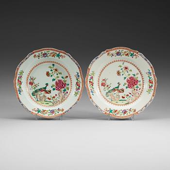 A set of seven deep and three flat famille rose 'double peacock' dishes, Qing dynasty, Qianlong.