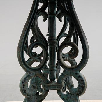 A early 20th Century cast iron garden table with later concrete top.