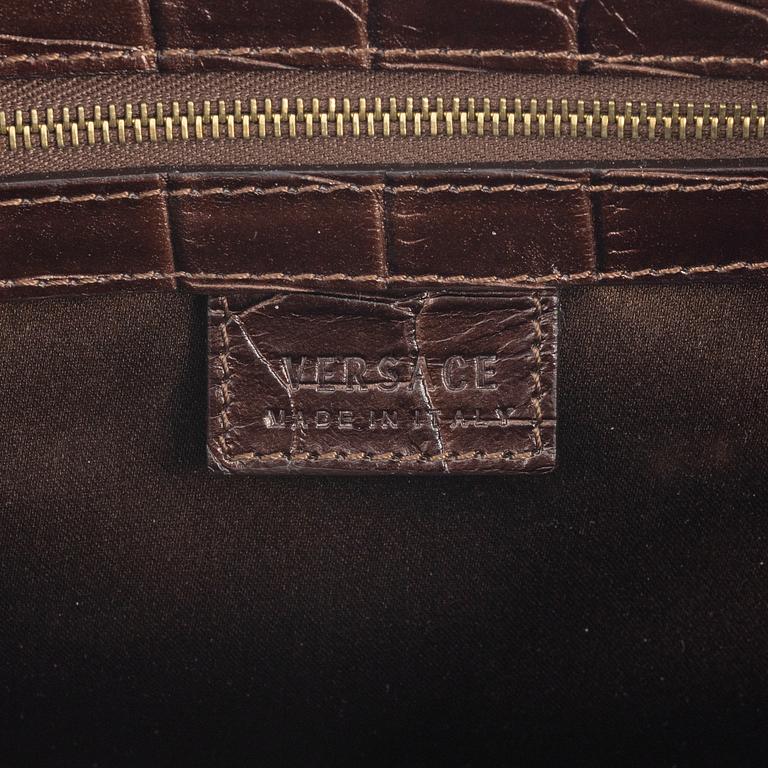 Versace, a bronze metallic leather handbag.
