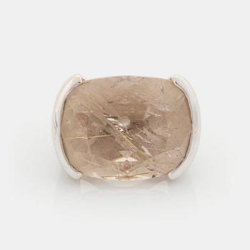 A Tina Karlsson ring in 18K white gold ring set with a faceted rutile quartz.