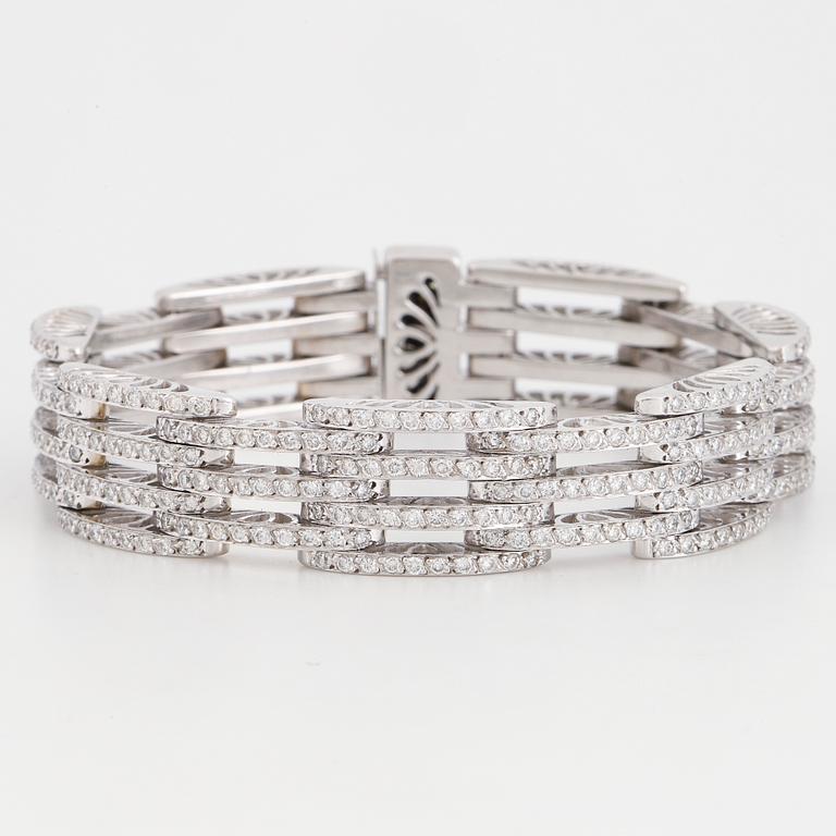An 18K white gold bracelet set with round brilliant-cut diamonds.