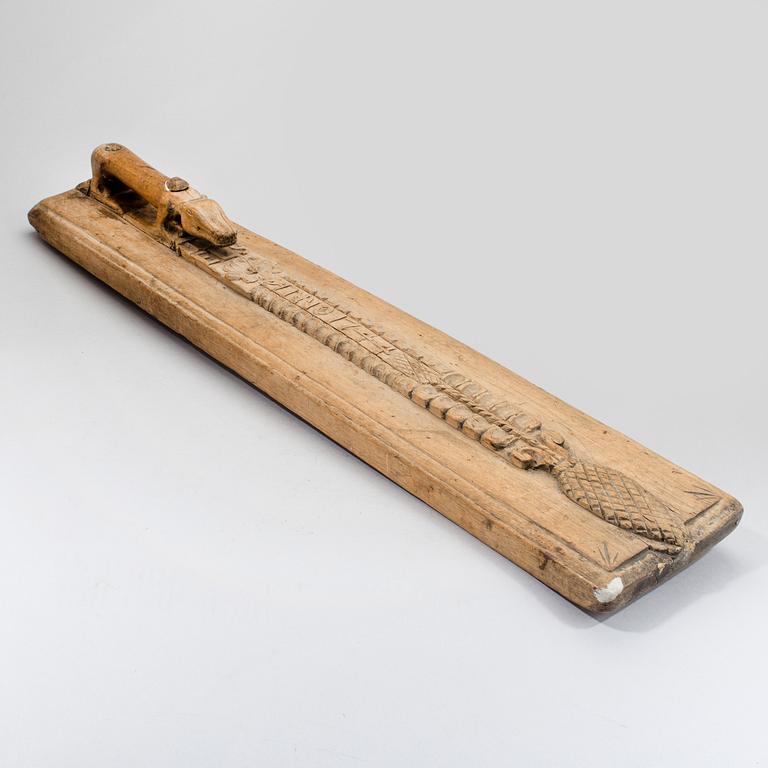A Swedish folk art mangle board with carved decorationd, owners' initials and the date 1744.