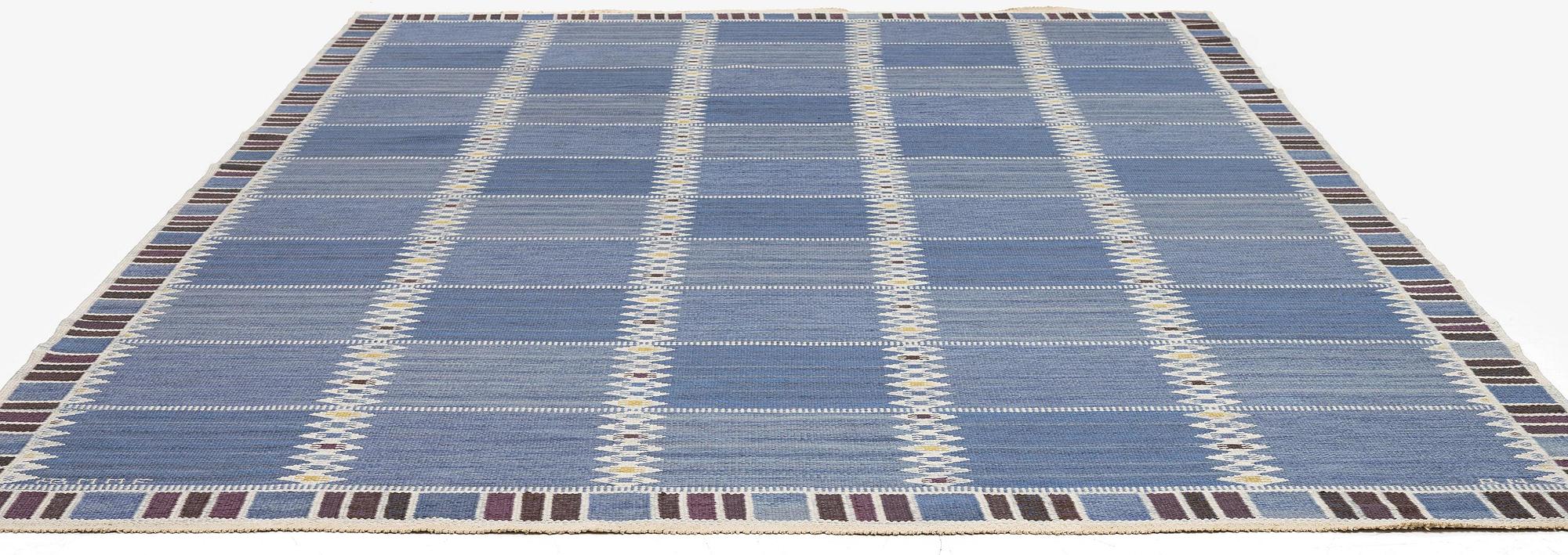 Barbro Nilsson, a carpet, 'Salerno blå med enkel bård', flat weave, c. 365 x 244 cm, signed AB MMF BN.