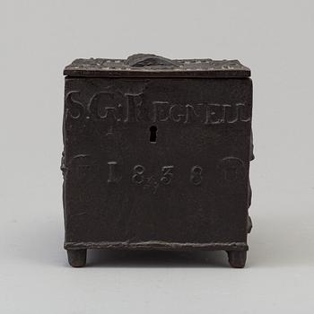 An empire cast iron tobacco box, dated 1838.