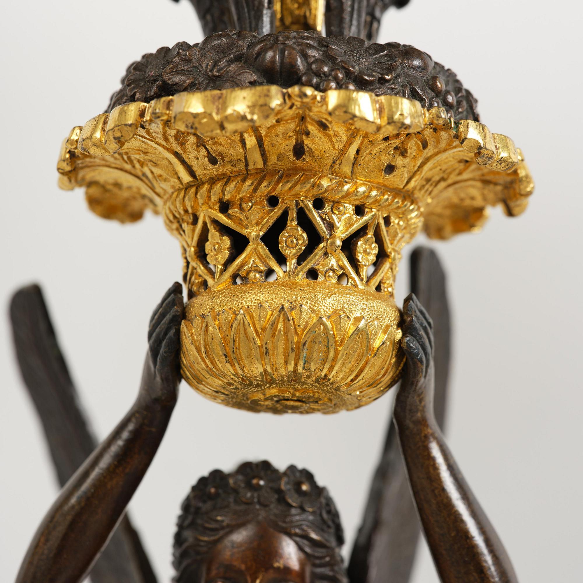 A pair of French Empire five-branch gilt and patinated bronze appliques, first part 19th century.