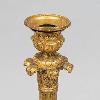 A pair of French Empire gilt-bronze candlesticks, early 19th century,