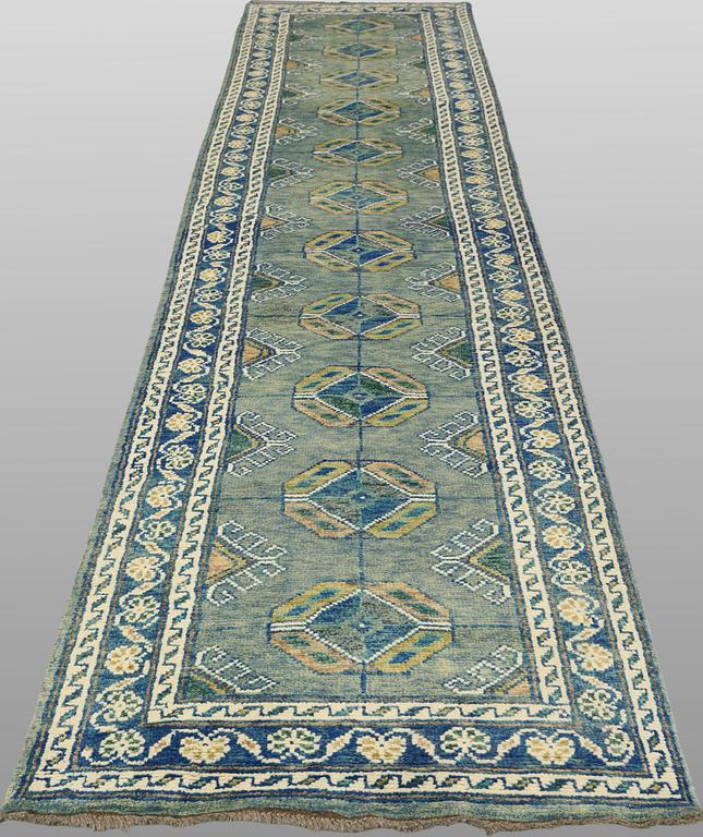An Oriental runner, c. 393 x 79 cm.