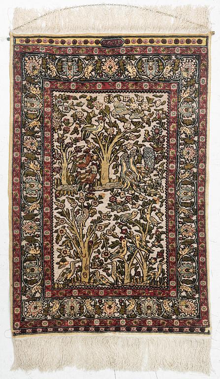 A figural silk Hereke rug, signed c. 92 x 61 cm.