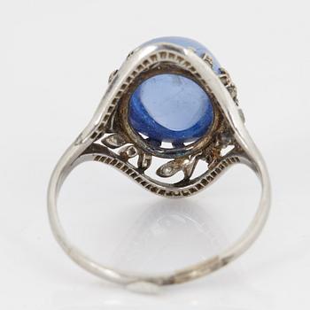 A RING set with a cabochon-cut sapphire.