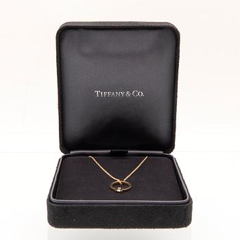 Tiffany & Co, "T" necklace in 18K gold with a baguette-cut diamond.
