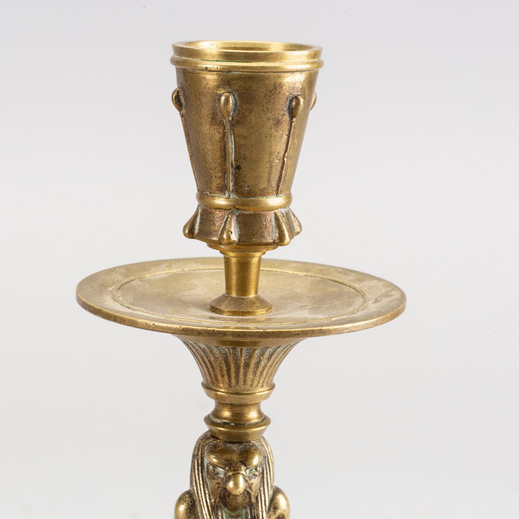 A pair of early 20th century brass candle sticks.