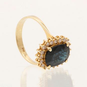 Ring in 14K gold with faceted sapphire and round brilliant-cut diamonds.