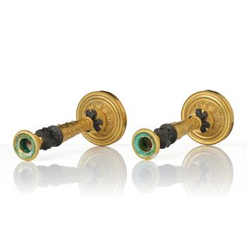 A pair of Napoleon III gilt and patinated bronze candlesticks, later part 19th century.