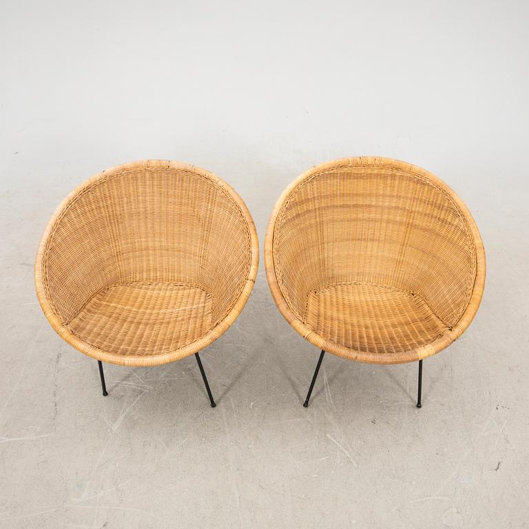 A pair of rattan 1950s easy chairs.