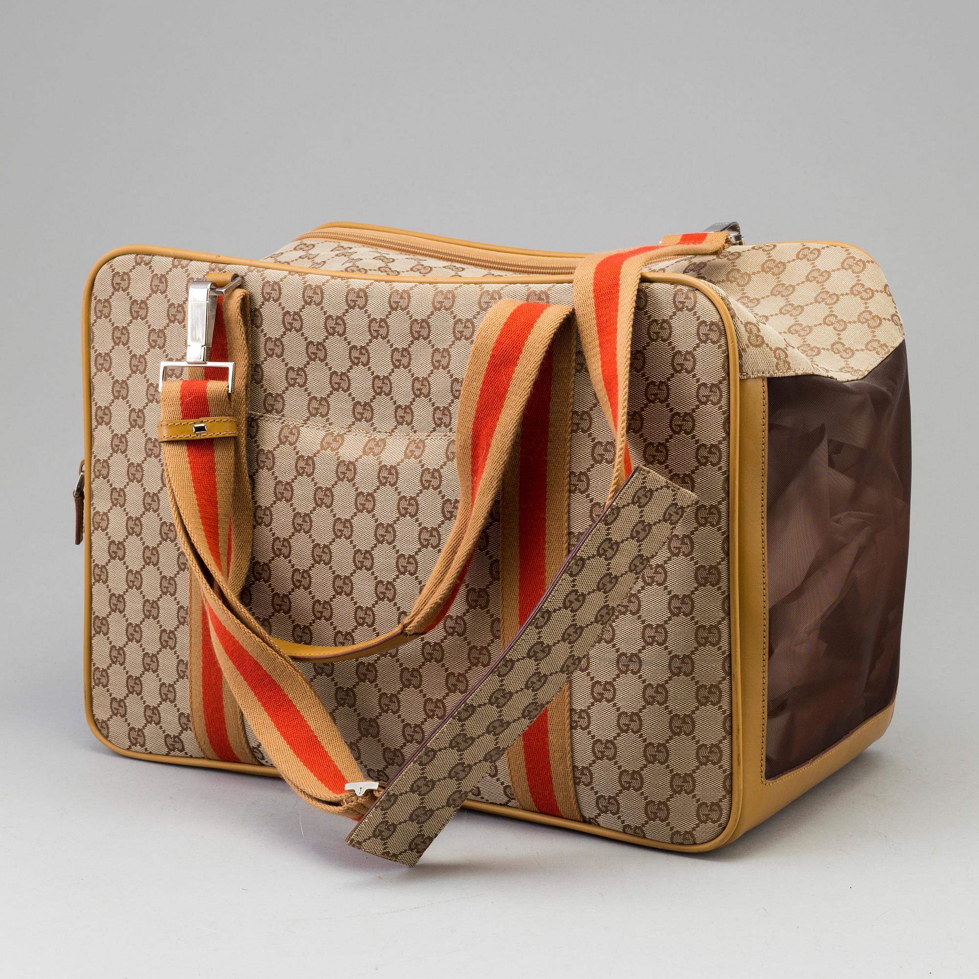GUCCI, a monogram canvas dog bag.