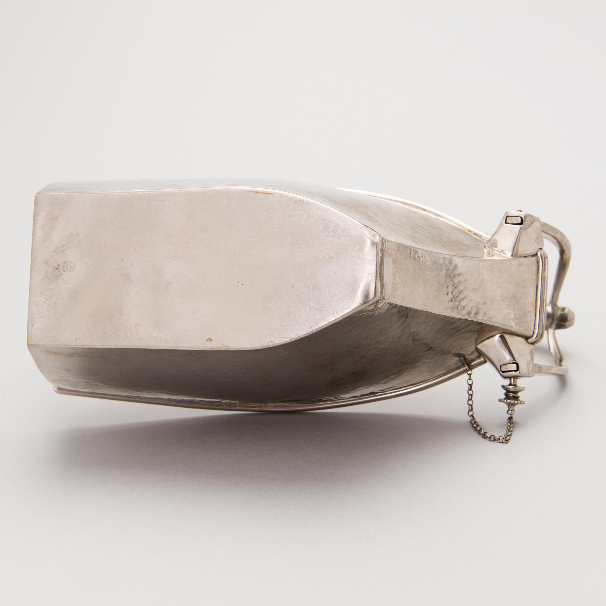 A metal wine bottle stand from WMF, Geislingen, Germany first half of the 20th Century.