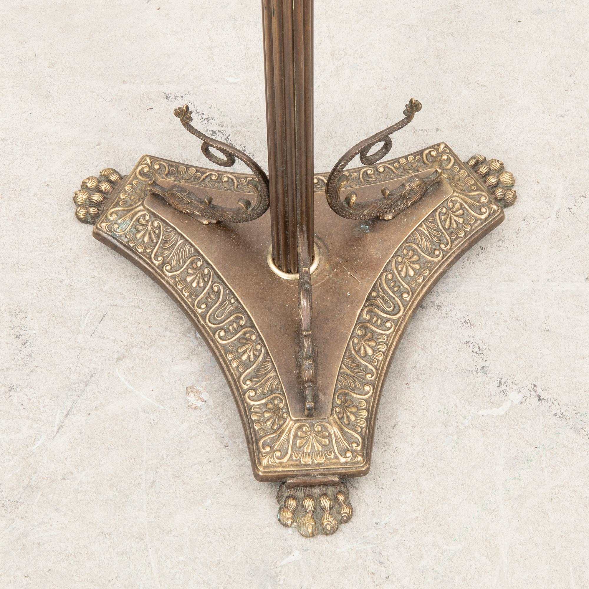 A brass coat hanger from the first half of the 20th century.