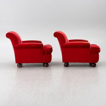 A pair of Howard-style armchairs and a footstool, late 20th century.